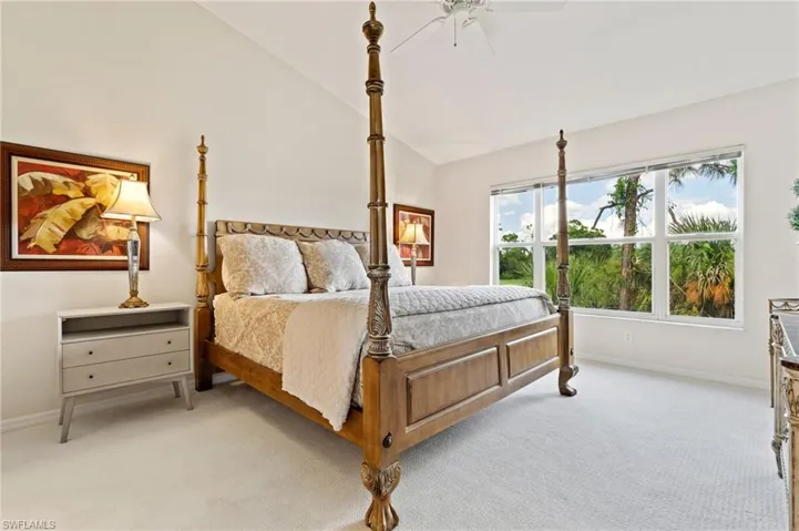 Vaulted white ceilings featuring a ceiling fan