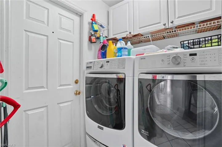 Laundry room with cabinet space and washing machine and clothes dryer