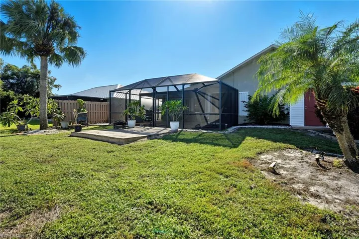 View of yard with a lanai, a sunroom, and a patio