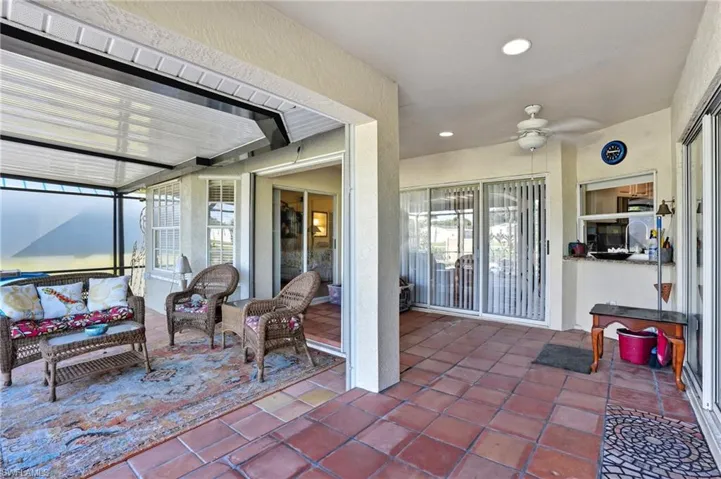 View of patio / terrace featuring a sunroom, ceiling fan, and an outdoor hangout area