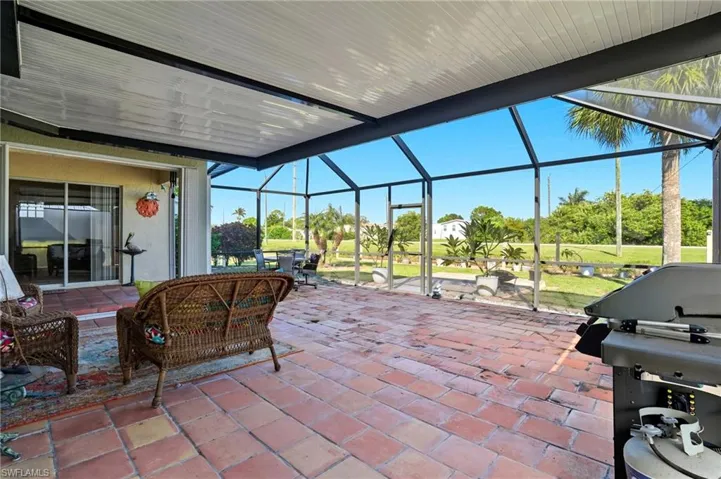 View of patio / terrace featuring a sunroom, glass enclosure, and grilling area