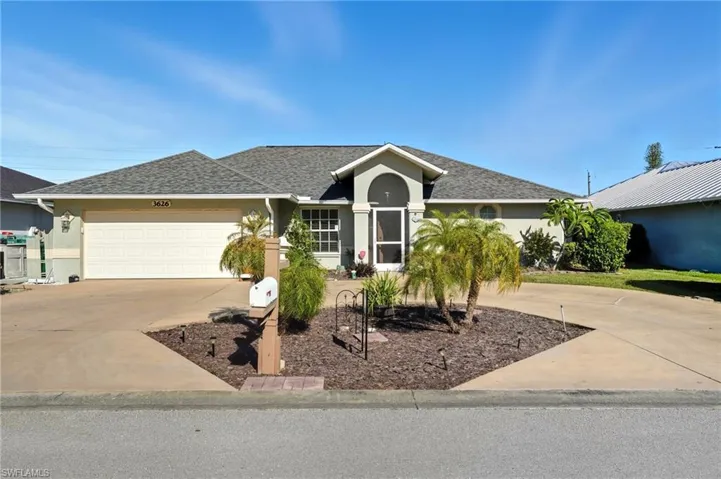 Single story home featuring driveway, roof with shingles, stucco siding, and a garage