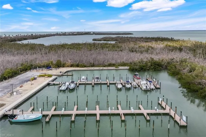 Birds eye view of property with a water view
