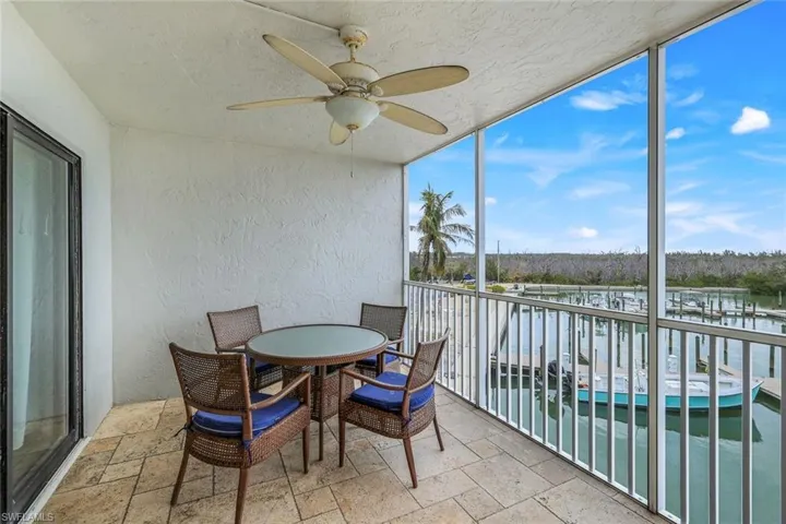Sunroom with a water view and ceiling fan