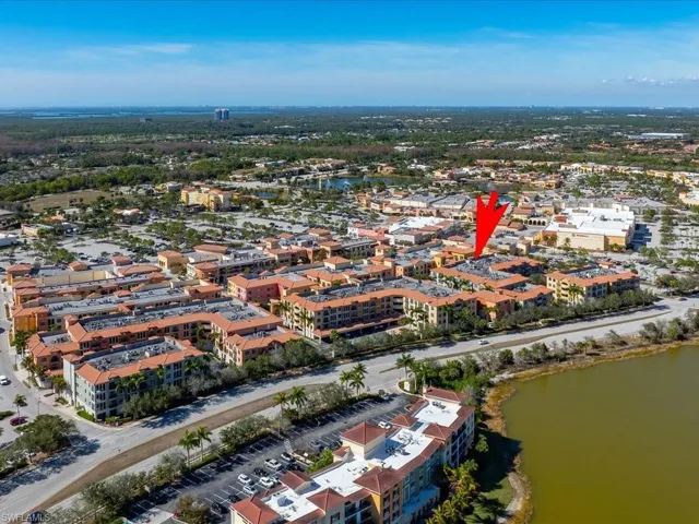 Aerial view of property and surrounding area featuring a large body of water