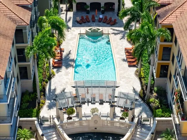 Community pool with a patio area and a community hot tub