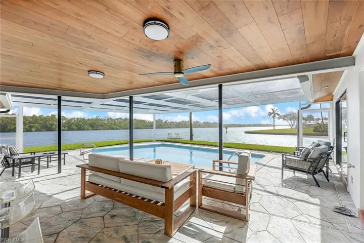 Screened Lanai with Panaramic View of River with a wealth of natural light, wood ceiling, and ceiling fan