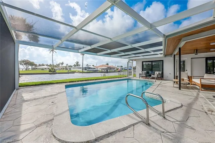 View of pool with a lanai and a patio