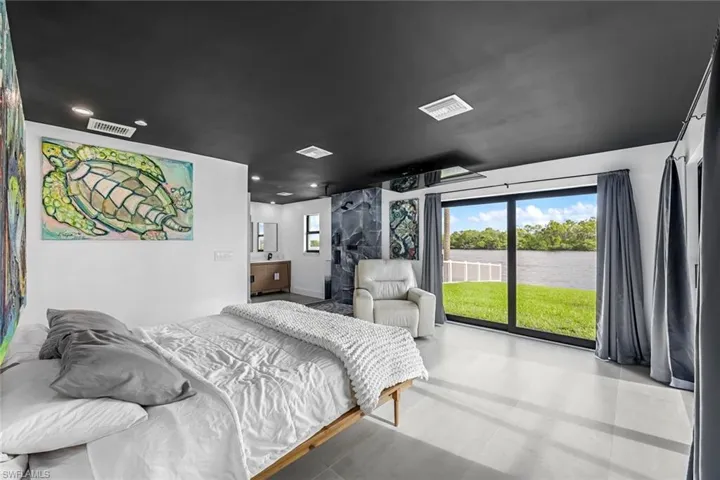 Master Bedroom with a water view and access to exterior