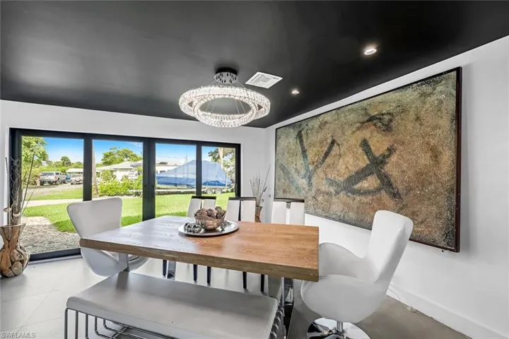 Dining space featuring an inviting chandelier and light tile floors