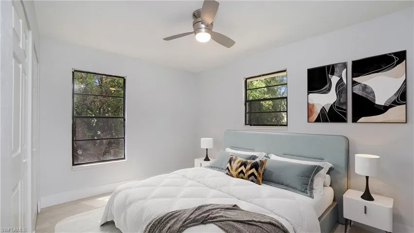 Bedroom #1 staged ceiling fan and light wood-type flooring