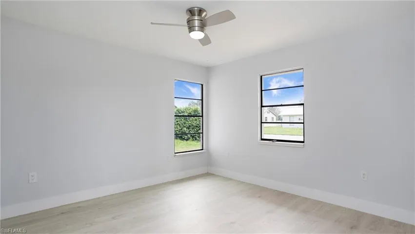 Unfurnished room with ceiling fan and light hardwood / wood-style floors