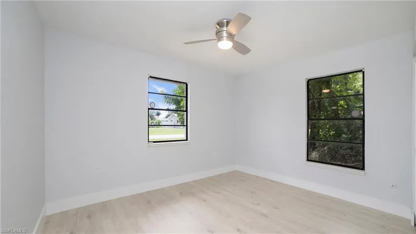 Unfurnished room featuring light wood-type flooring and ceiling fan