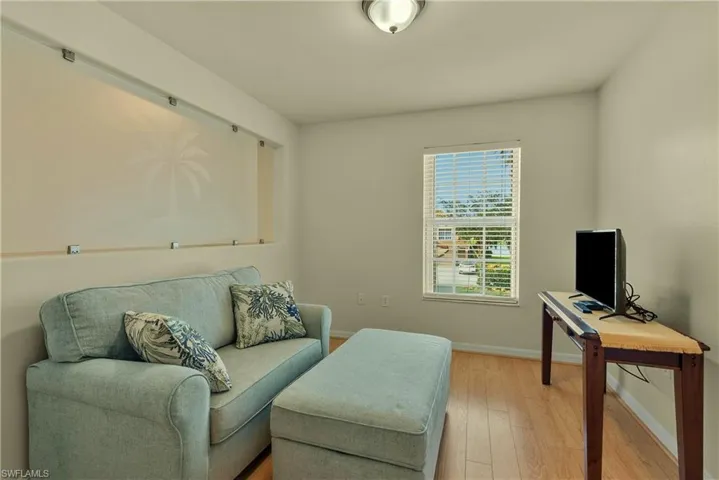 Sitting room featuring hardwood / wood-style floors and baseboards