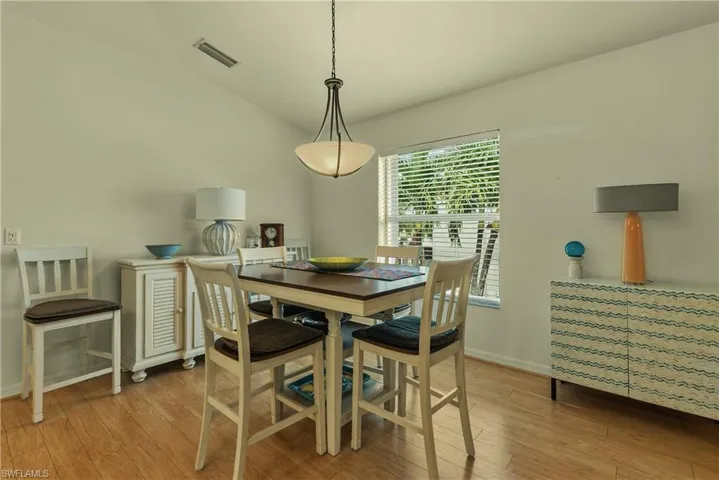 Dining area featuring lofted ceiling and light wood-style floors