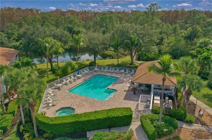 Community pool with a community hot tub, a patio area, and a water view