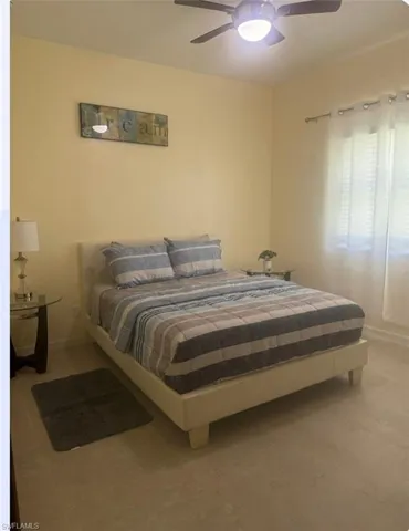 Bedroom with a ceiling fan and baseboards