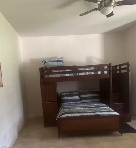 Bedroom featuring a ceiling fan and light tile patterned floors