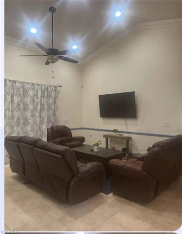 Living room featuring crown molding, recessed lighting, a ceiling fan, and light tile patterned floors