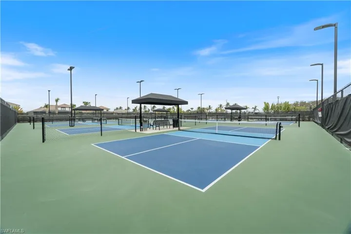 View of tennis court with a gazebo