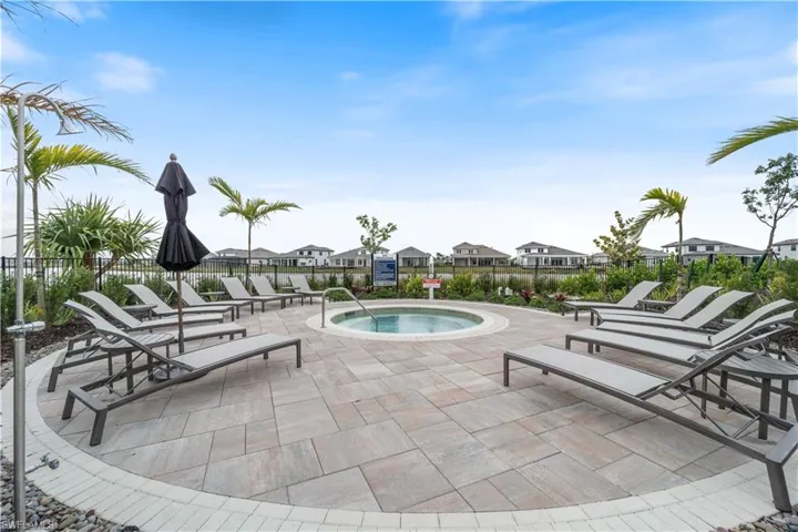 View of swimming pool with a community hot tub and a patio