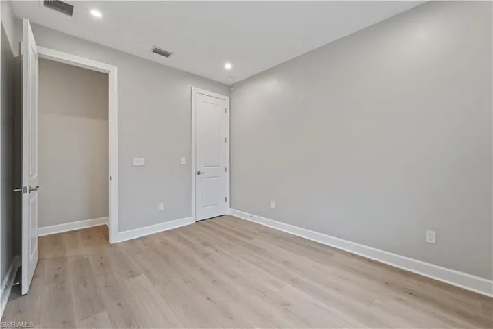 Unfurnished bedroom with light wood-type flooring