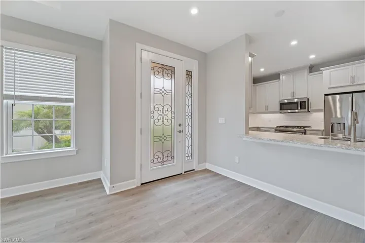 Foyer featuring sink and light hardwood / wood-style flooring
