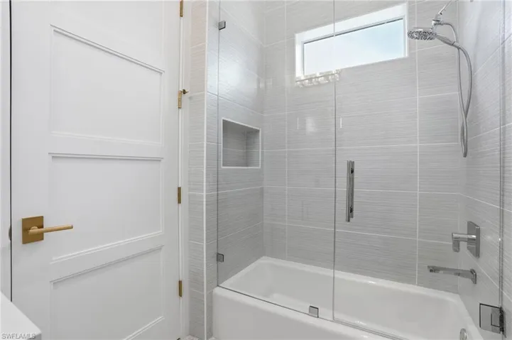 Bathroom with enclosed tub / shower combo