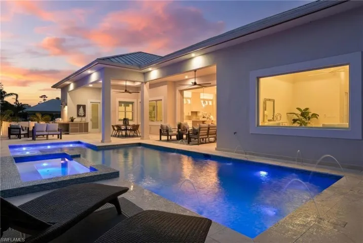 Integrated pool / hot tub featuring a patio area and outdoor lounge area