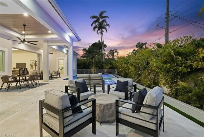 View of patio with an outdoor living / dining area and a ceiling fan