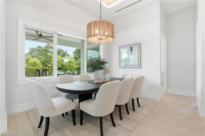 Dining room featuring light wood-style flooring and a skylight