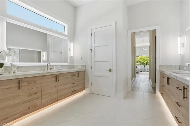 Bathroom featuring vanity and light marble finish flooring