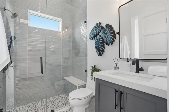 Full bathroom with vanity and a shower stall