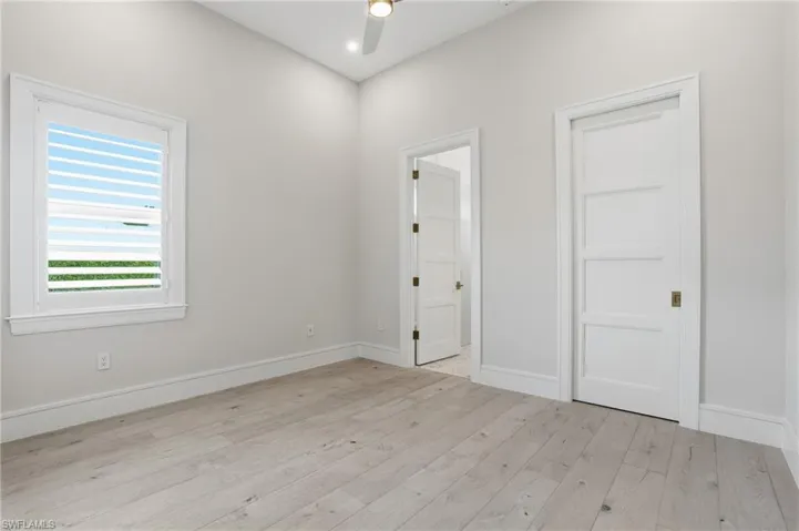 Unfurnished bedroom with light wood-style flooring, a ceiling fan, and recessed lighting