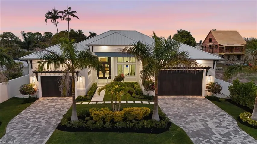 View of front of house featuring driveway, an attached garage, and stucco siding