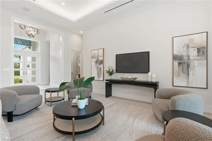 Living room featuring a high ceiling and hanging lights