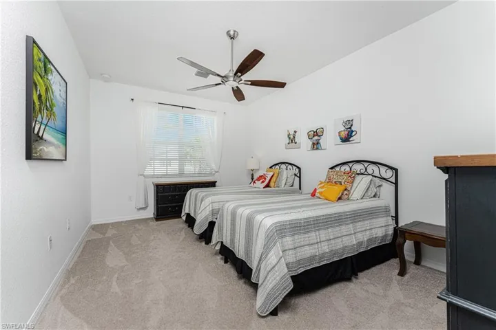 Bedroom with ceiling fan, baseboards, and carpet floors