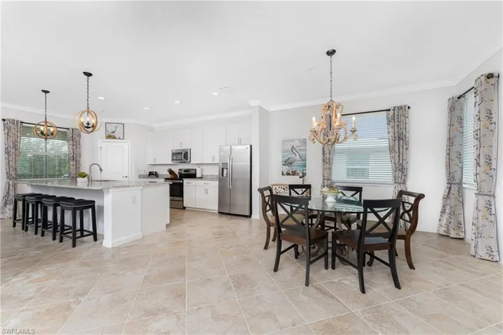 Dining room featuring a chandelier, recessed lighting, and ornamental molding
