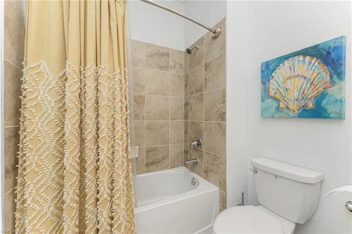 Full bathroom featuring toilet and shower / tub combo