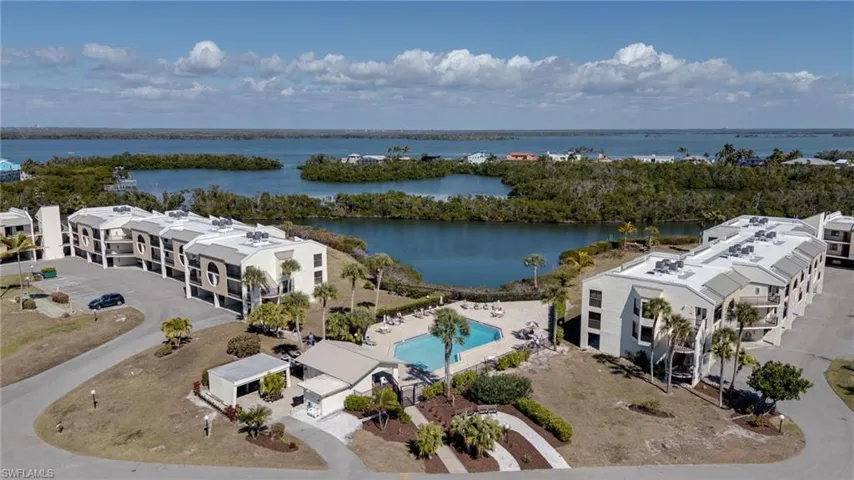 Drone / aerial view of apartment complex and a nearby body of water