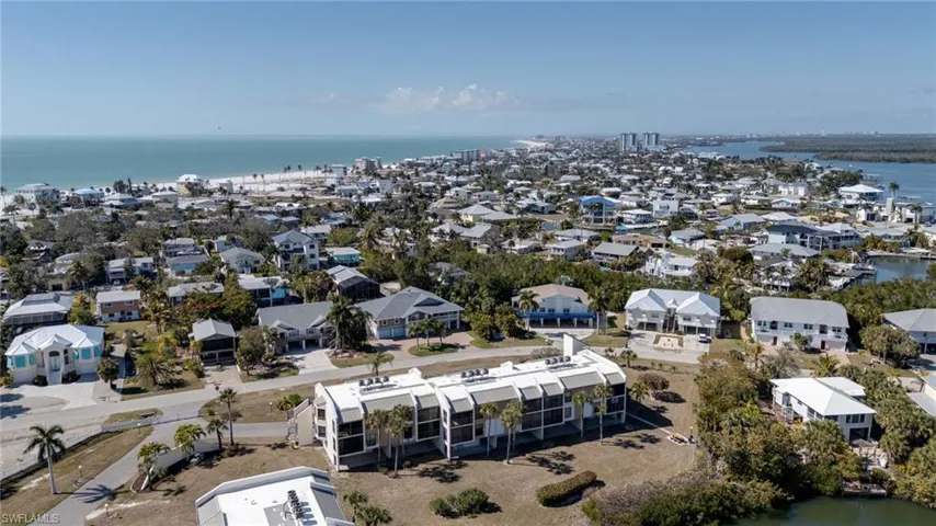 Aerial perspective of suburban area with a nearby body of water