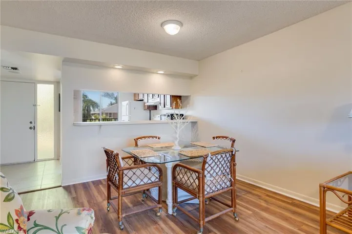 Dining room featuring wood finished floors and a textured ceiling