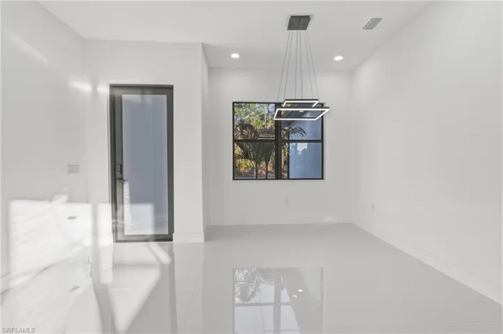 Unfurnished dining area with tile patterned floors and recessed lighting