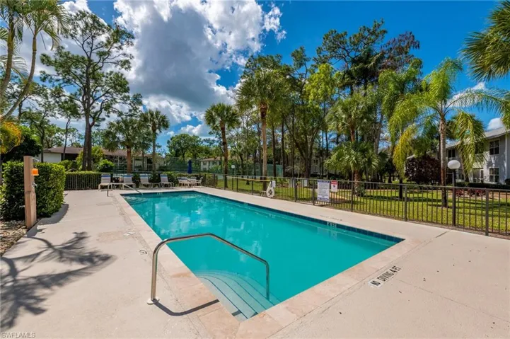 Community pool with a patio
