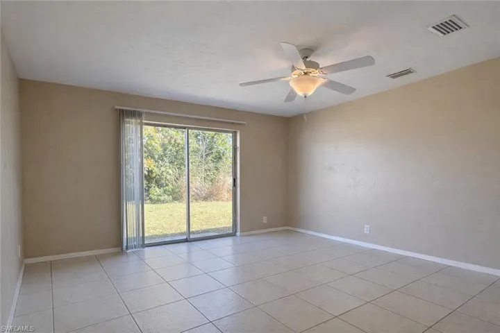 Unfurnished room featuring ceiling fan and light tile patterned floors