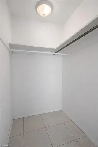 Walk in closet featuring light tile patterned flooring