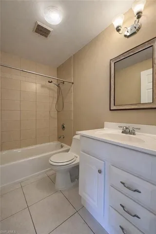 Bathroom featuring vanity, light tile patterned floors, and shower / bath combination