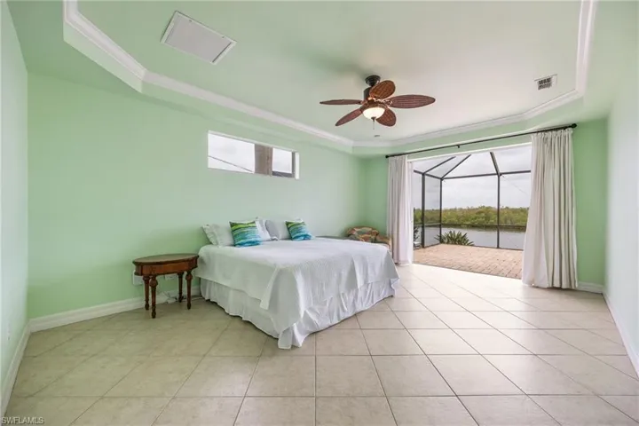 Primary bedroom with sliders to the pool deck