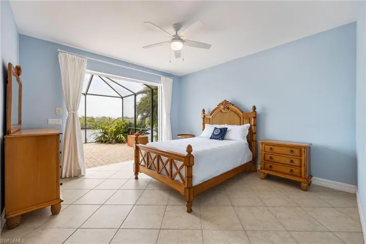 2nd bedroom downstairs with sliders to the pool deck