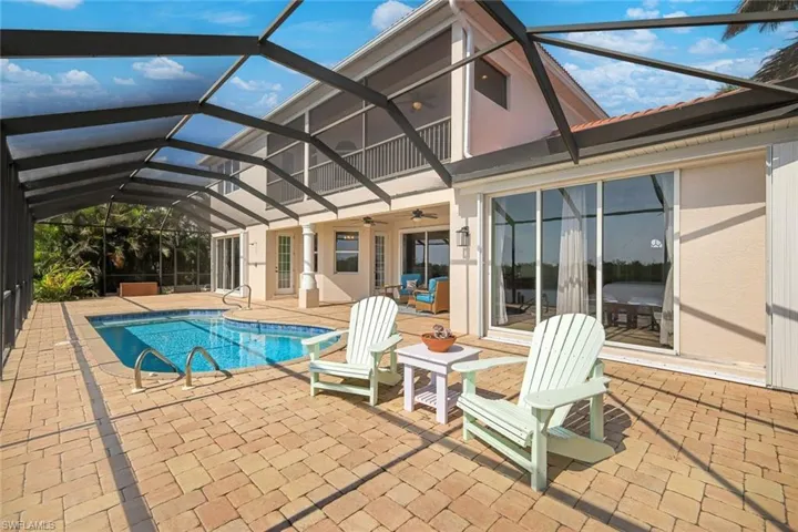 Screened outdoor oasis by the water to enjoy views from the pool, patio or under the overhang with ceiling fans